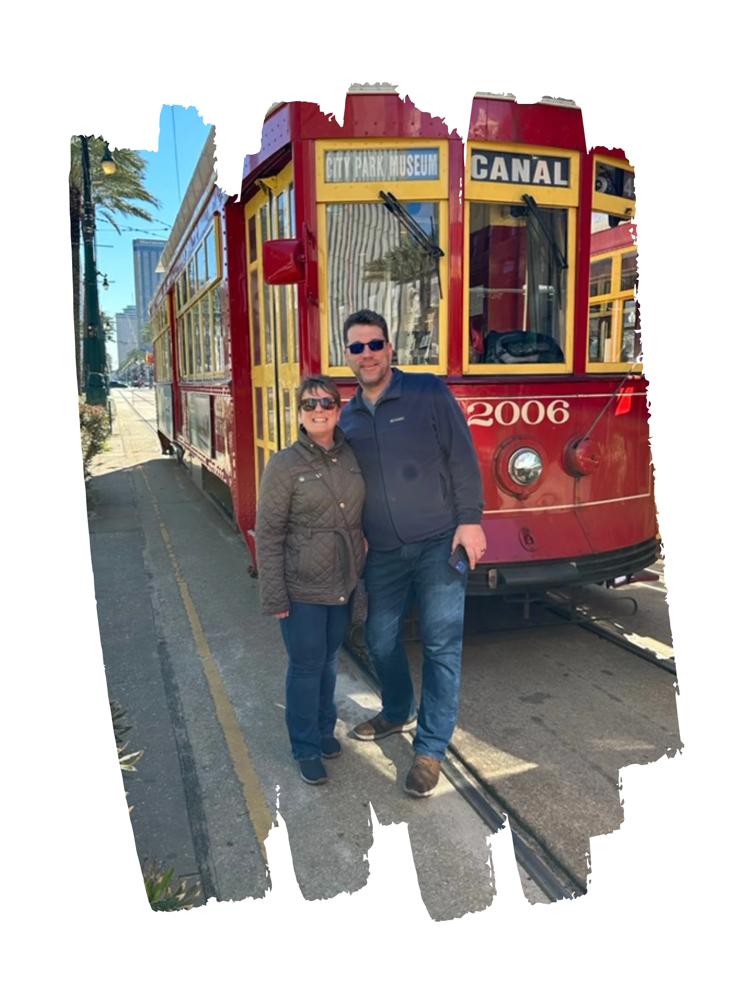 Mike and Andrea beside a red streetcar